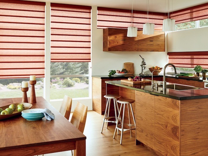 A kitchen with bowls of fruit and vegetables.